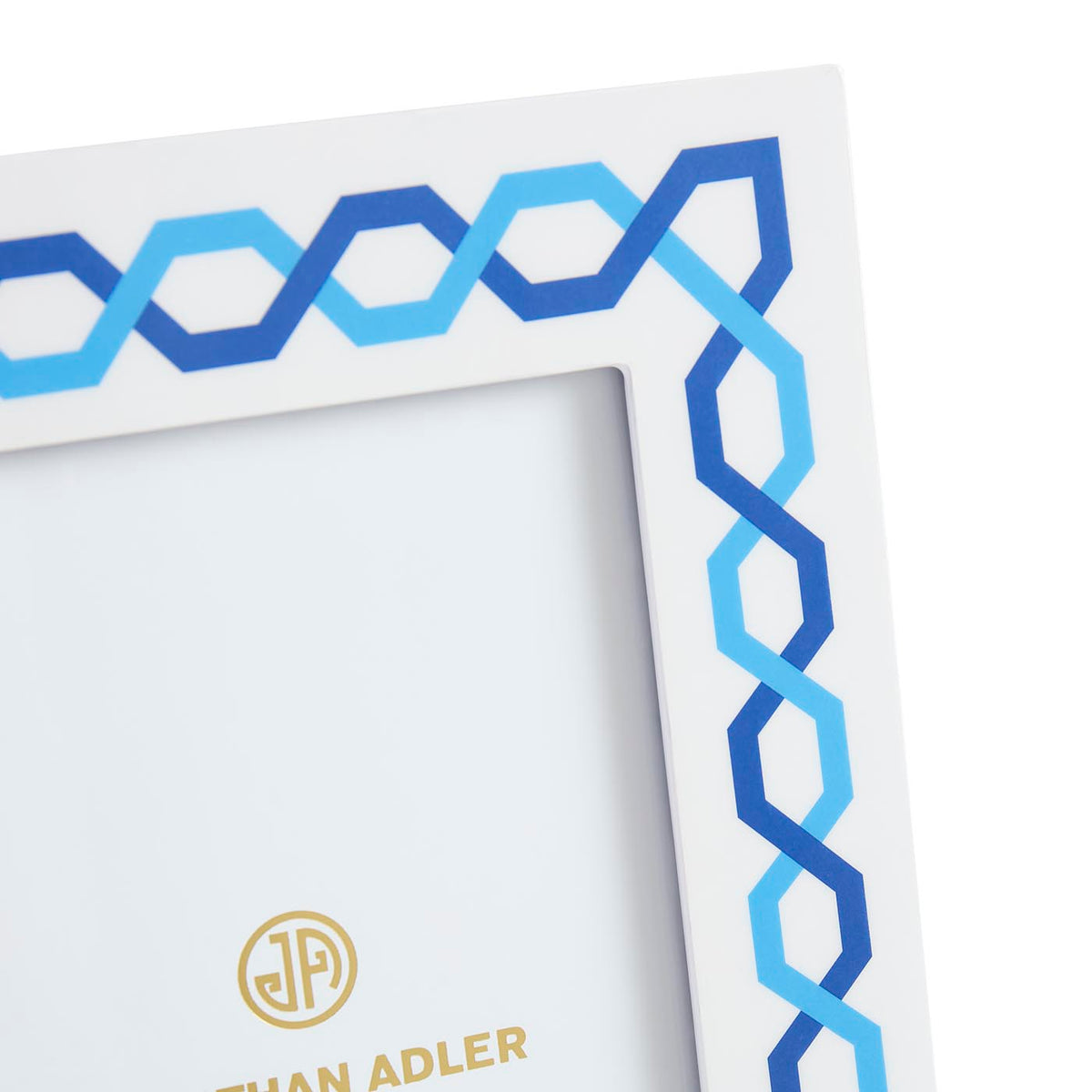 Framed artwork with blue geometric pattern and 'Johan Adler' logo.