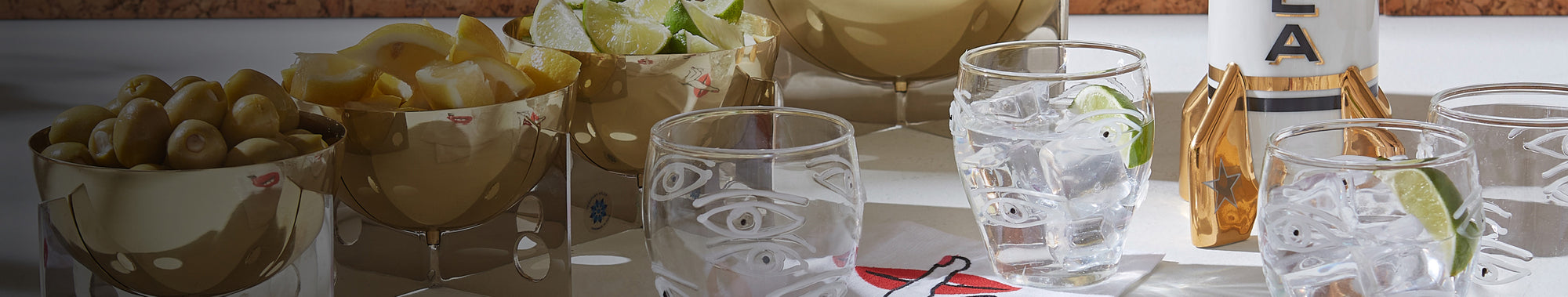 Stemless cocktail glasses and bowls of drink garnishes