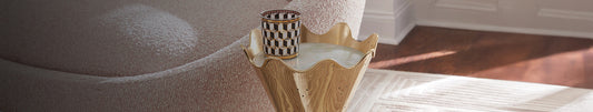Gold decorative side table with a graphic votive