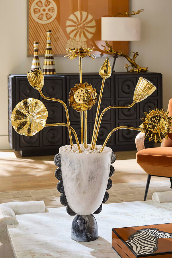 Decorative gold flowers in a stylish black and white vase