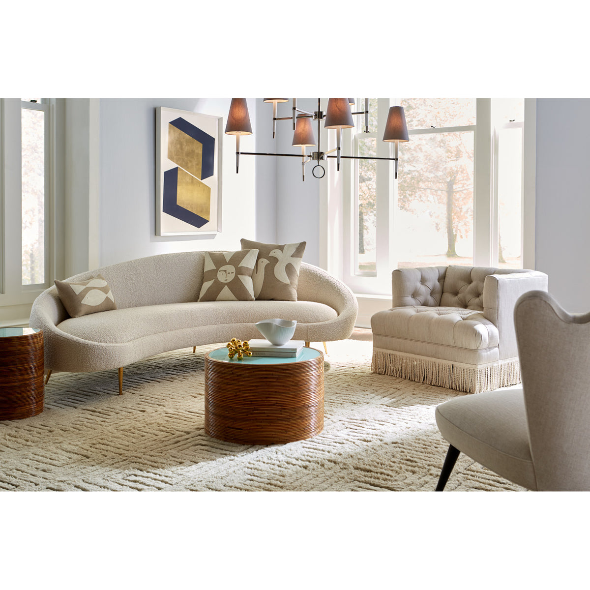 ether curved sofa olympus oatmeal riviera cocktail table baxter t-arm chair with bullion fringe - styled view