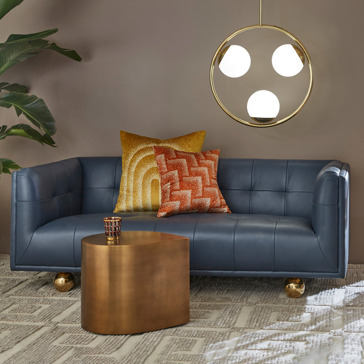 claridge apartment sofa vapor pillows brass teardrop side table saint germain hand knotted rug - styled view