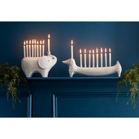 ceramic elephant and dachshund menorahs with candles - styled view 1