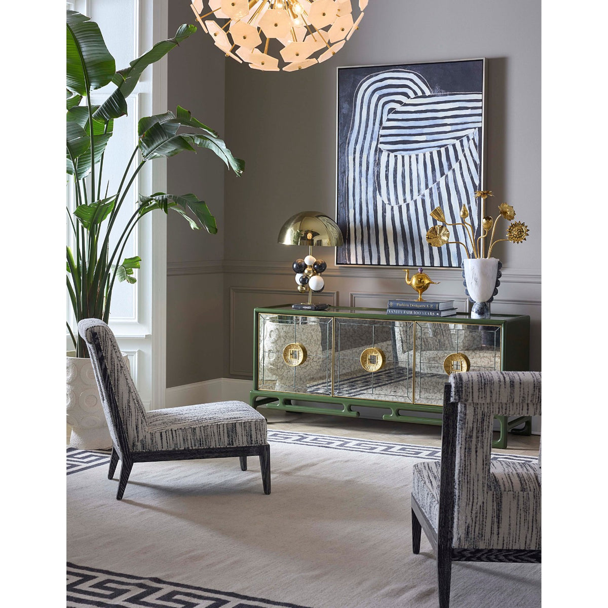 Modern interior with a glass console table, chairs, and abstract art on the wall.