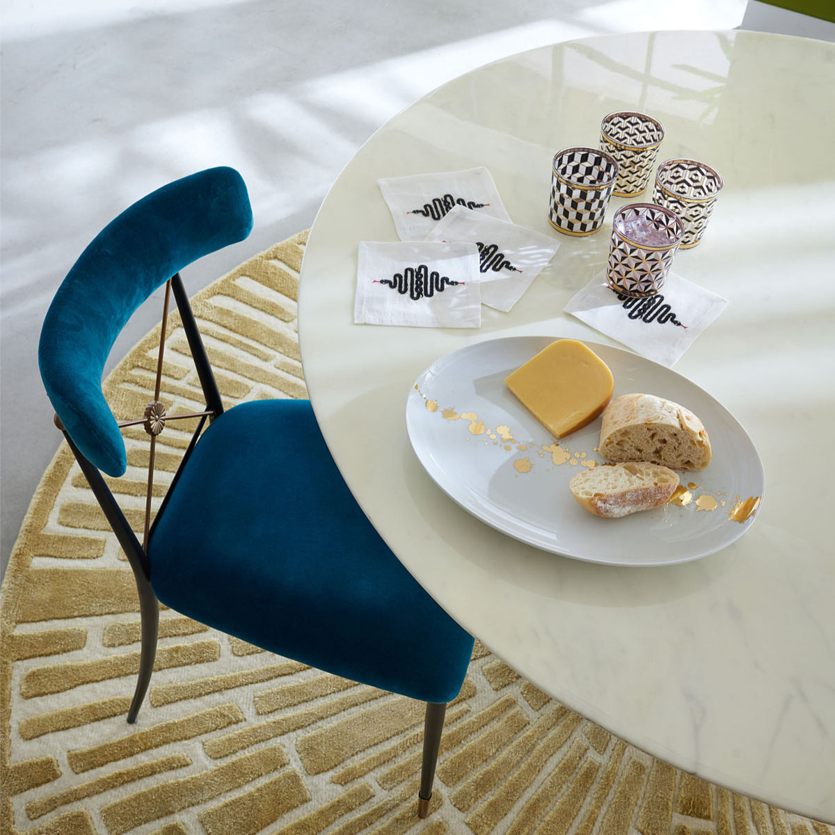 sunburst hand-knotted round rug wool gold with rider dining chair