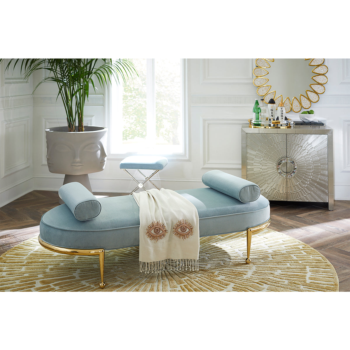 sunburst hand-knotted round rug with charade capsule daybed