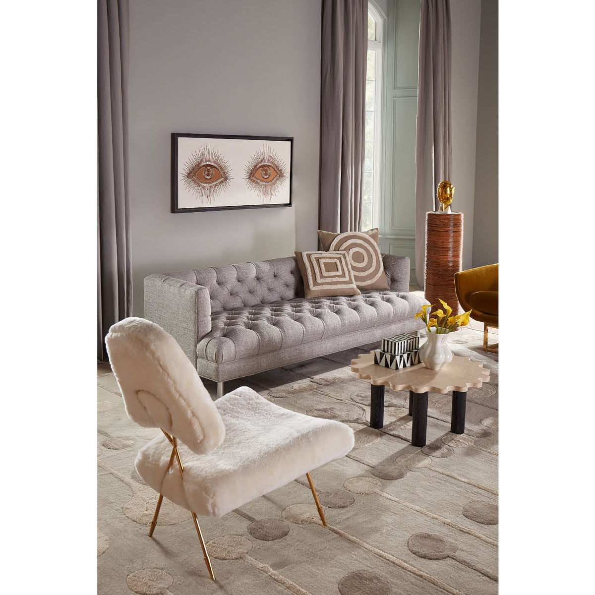 eyes beaded wall art baxter t-arm sofa ripple circle travertine cocktail table - styled view