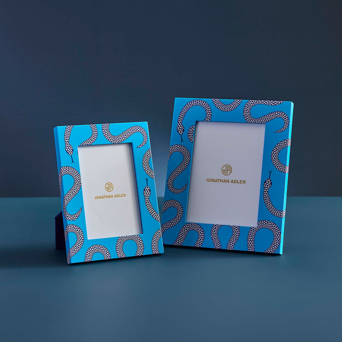 Two blue photo frames with decorative patterns on a dark blue background