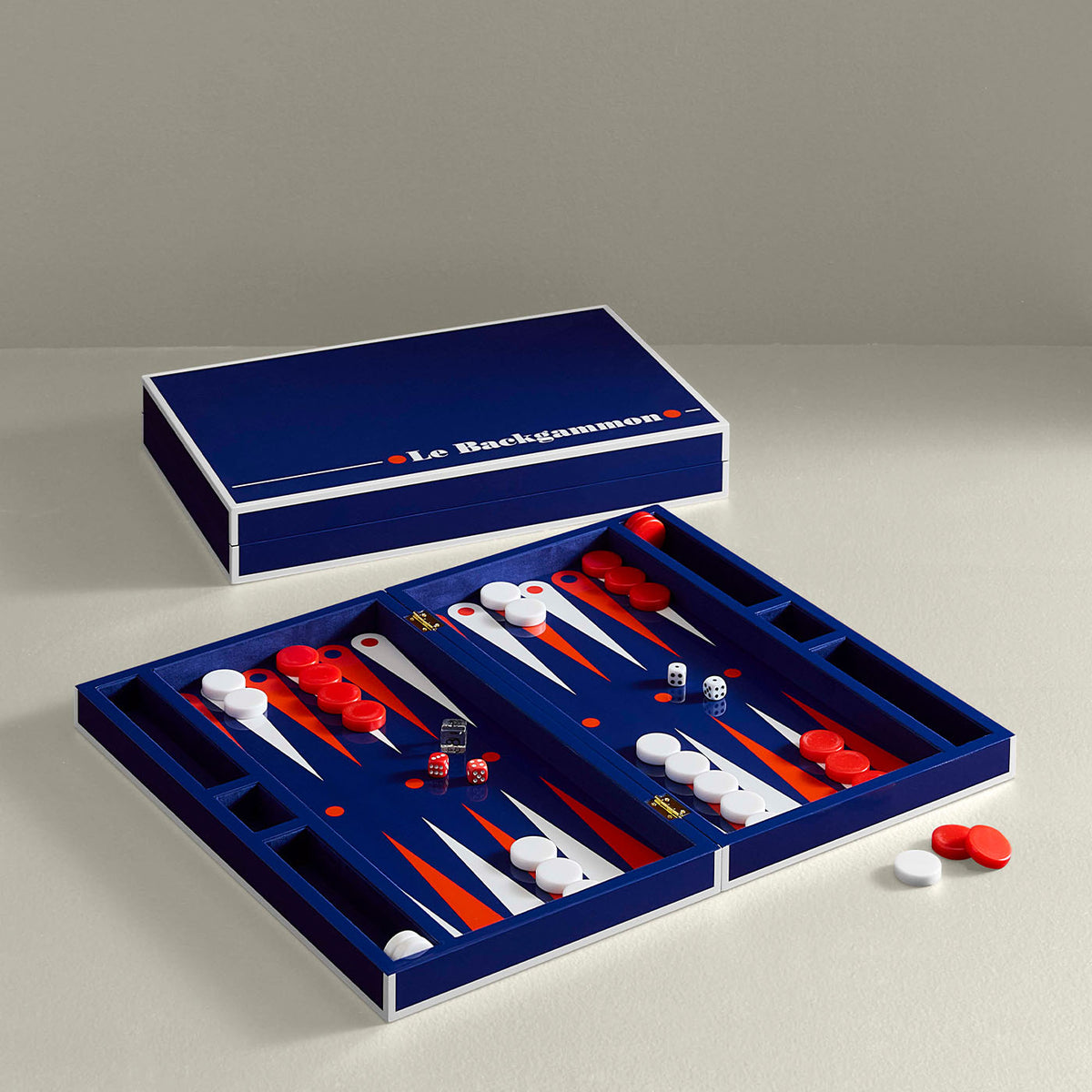 Backgammon set with blue board and red and white pieces on a gray background