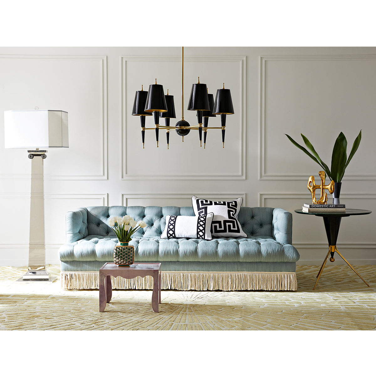 versailles chandelier with painted shade black baxter t-arm sofa with bullion fringe - styled view