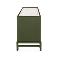 Green metal side table with a white glass top on a white background