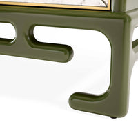 Close-up of a green metal chair frame on a white background