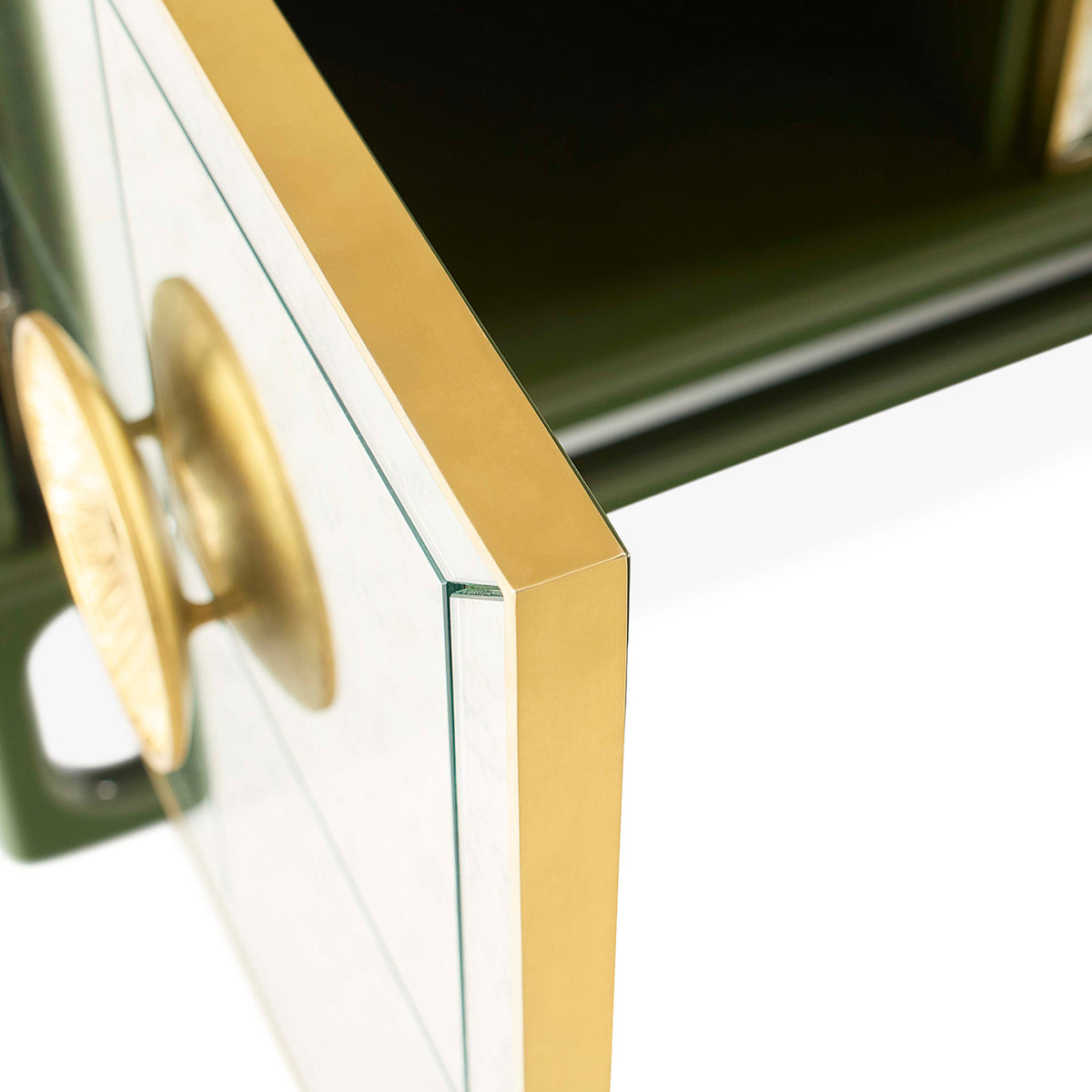Close-up of a green and gold cabinet with a glass panel.