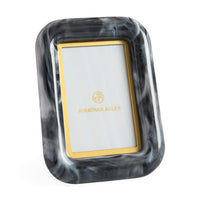 Marble-patterned photo frame with gold border on a white background
