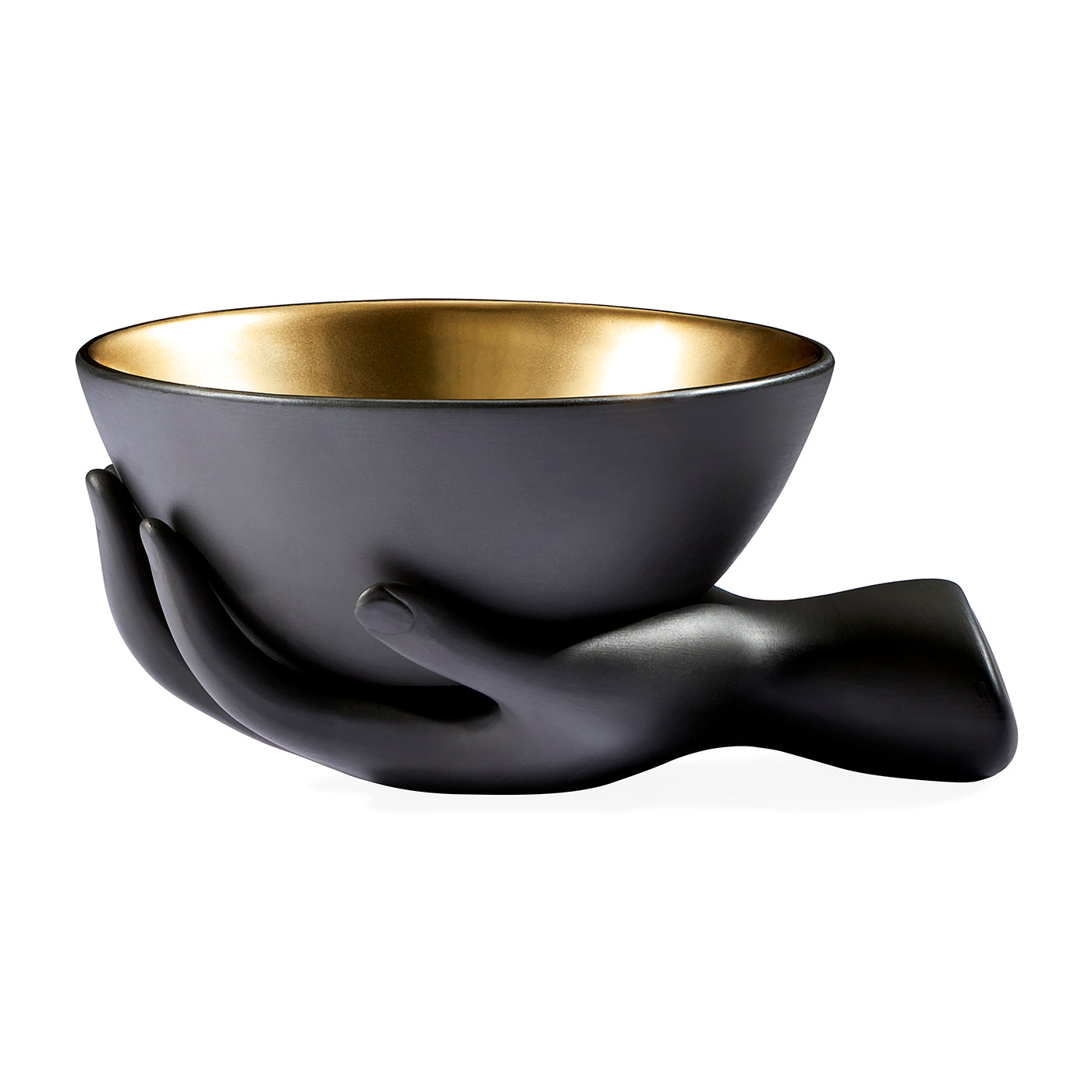 A matte black ceramic bowl with a polished gold interior, sculpted to be held by two stylized hands, shown on a plain white background.