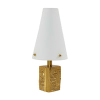 Table lamp with gold base and white shade on a white background