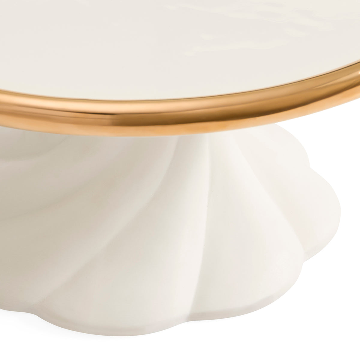 Close-up of a white pedestal table base with a fluted scalloped edge and a polished gold metal rim, shown against a white background.
