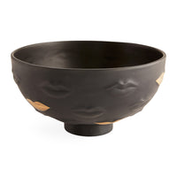 Black ceramic bowl with gold accents on a white background