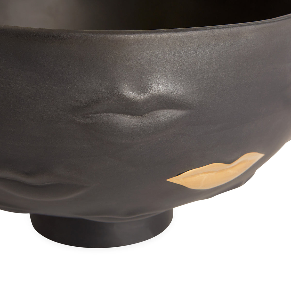 Black bowl with gold accents on a white background
