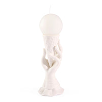 White ceramic sculpture of a figure with a spherical head on a white background