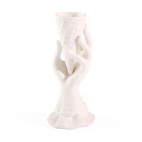 White ceramic vase with abstract design on a white background