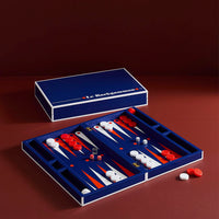 Backgammon set with pieces and dice on a dark red background