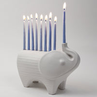 ceramic elephant menorah white with blue candles - angle view