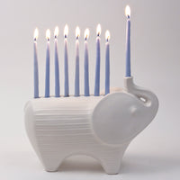 ceramic elephant menorah white with blue candles lit - angle view