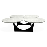 Modern coffee table with four round marble top sections on a white background