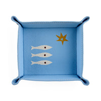 Blue leather tray with fish and star design on a white background