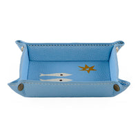 Blue leather tray with fish and star design on a white background