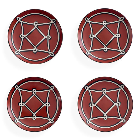 Four round red coasters arranged in a 2x2 grid on a white background, each featuring a white geometric rope-knot design over a circular motif.