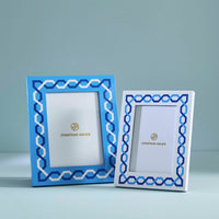 Two decorative picture frames with blue geometric patterns on a light blue background
