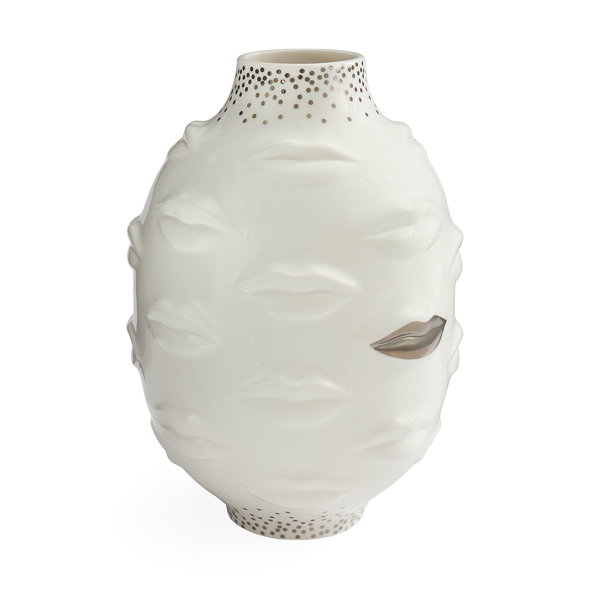 A white ceramic vase sculpted with a stylized face, featuring textured lips, closed eyes, and a metallic silver leaf detail on one eye. The neck and base are decorated with small metallic gold dots, set against a plain white background.
