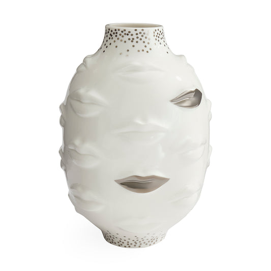 A white ceramic vase sculpted in the shape of a stylized face with cutout details for the eyes, nose, and mouth, featuring a dotted pattern on the neck and base.