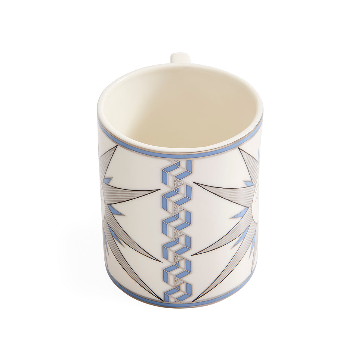 A white ceramic mug with a blue and gray geometric pattern, shown from a three-quarters perspective on a white background.