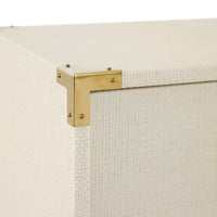 Close-up of a gold bracket on a textured white surface