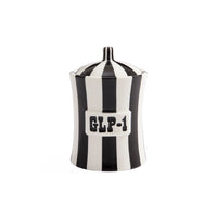 A black and white striped ceramic jar with a lid, featuring a white label on the front with the text 'GLP-1' in black.